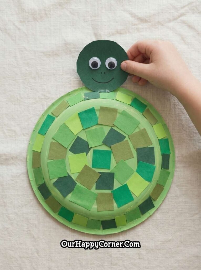 turtle head with googly eyes being attached