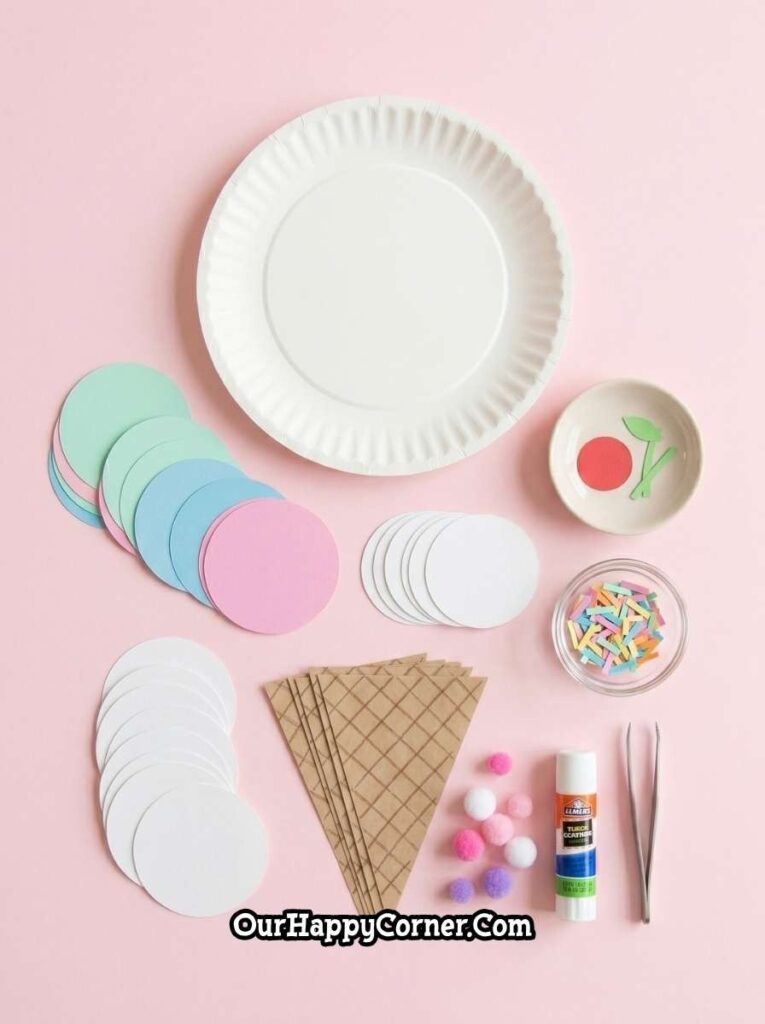 Materials for the craft including colorful paper circles, sprinkles, glue, and pom-poms 