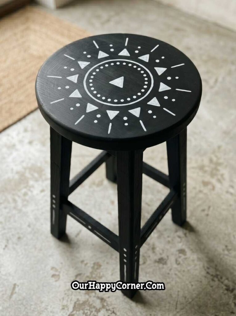 Black stool painting with white boho sunburst and geometric details