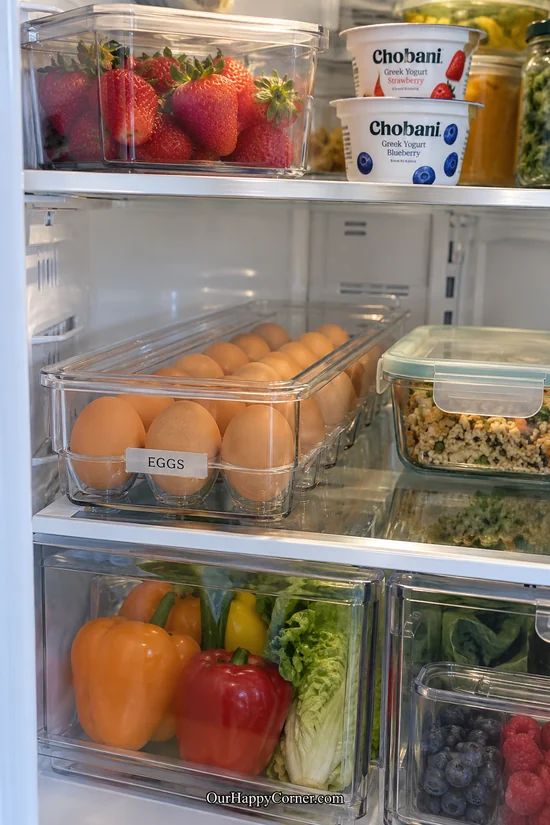 Covered clear egg tray on an interior refrigerator shelf