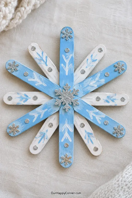Blue and white craft stick snowflake with silver stickers