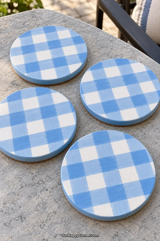 Round wooden coasters painted with blue and white gingham checks
