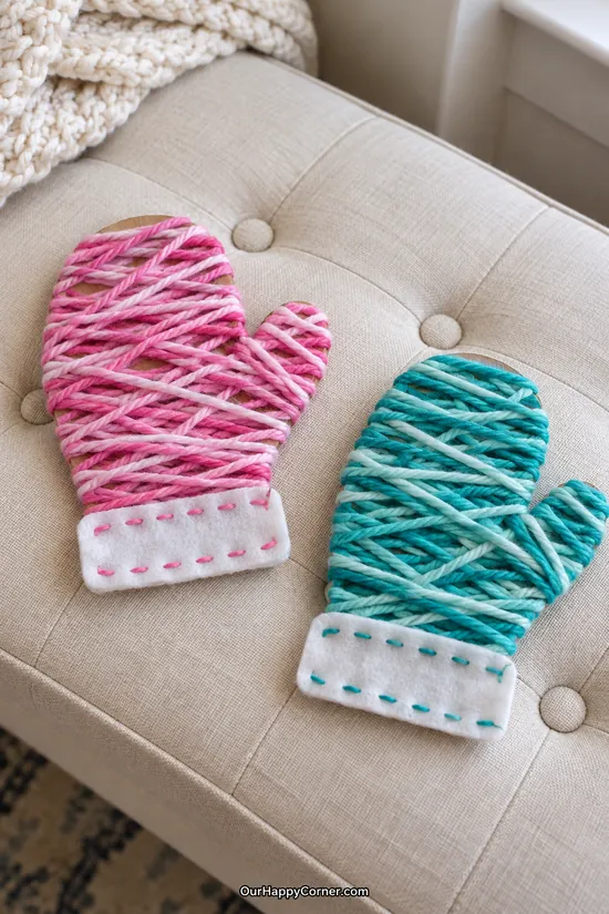 Pink and teal yarn wrapped cardboard mittens