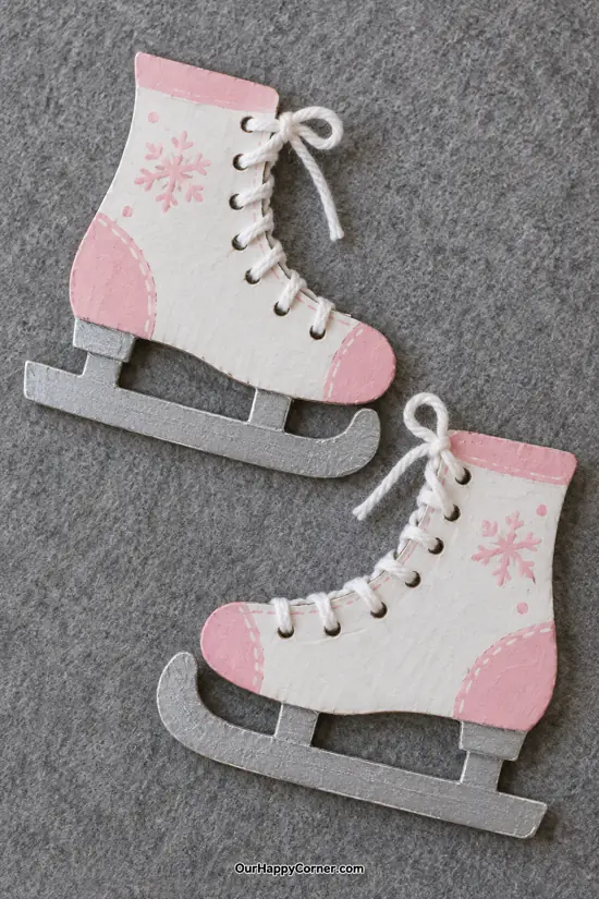 White and pink cardboard ice skates with yarn laces